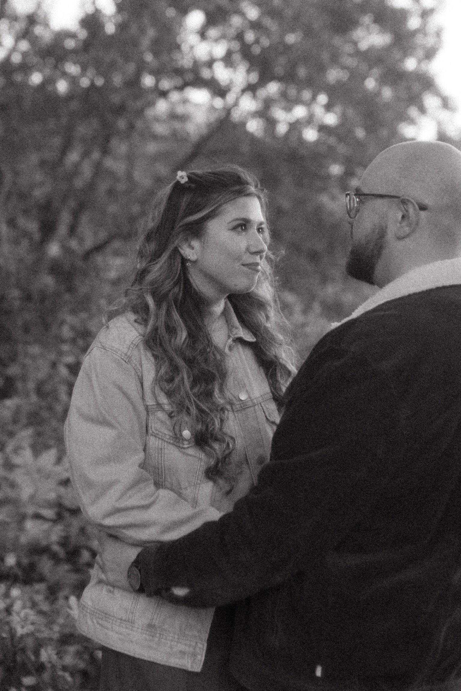 In black and white: Nicole looking up at Ian, his arm around her.