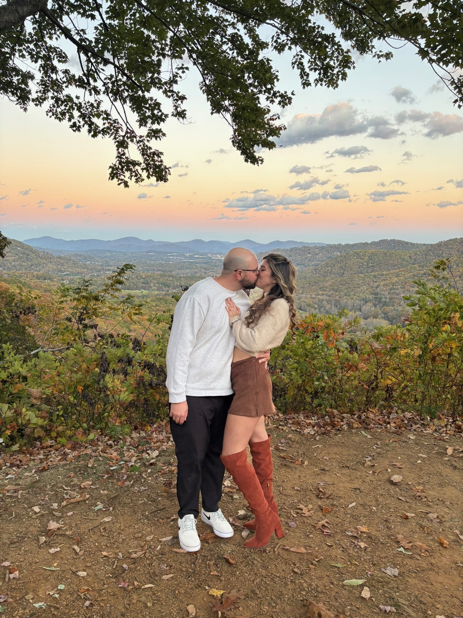 At sunset at the overlook: Nicole and Ian kissing beneath the spreading tree.