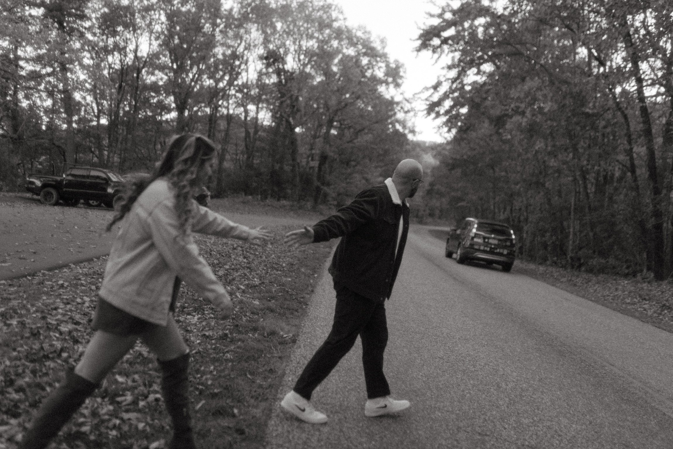 In black and white: the two of them crossing the road hand in hand.